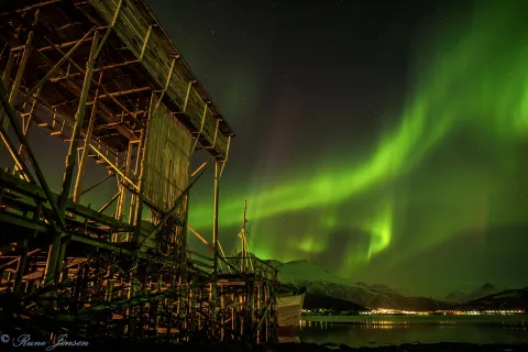 Coastal heritage sites along the Gratangen fjord glowing under the dance of Lady Aurora.