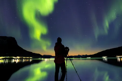 Northern Lights dancing over the fjord at Langstranda, captured in all their Arctic beauty.